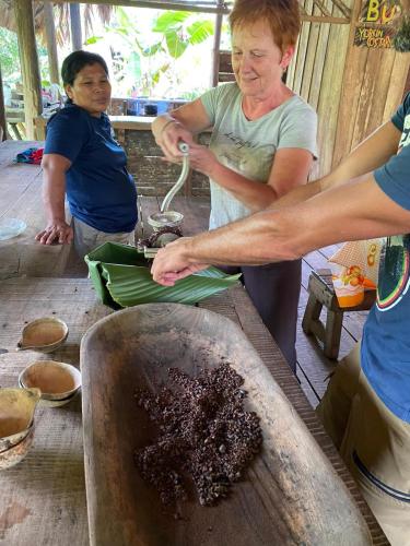 a group of people preparing food on a table at Hotel El Colibri Rojo - Cabinas - Le Colibri Rouge in Cahuita