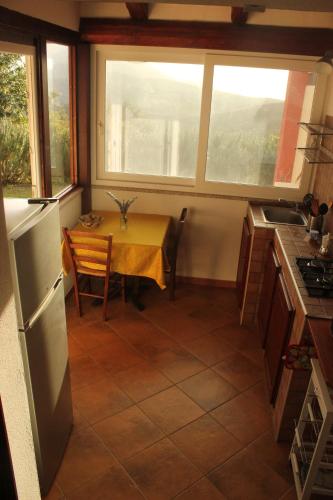 a small kitchen with a table and a window at Fighezia in Fluminimaggiore