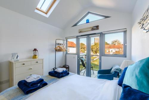 a bedroom with a bed and a window at 72a High Street in Southwold