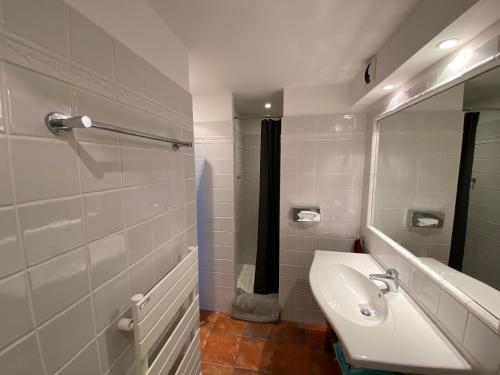 a bathroom with a sink and a mirror at Les Terrasses du Mirage grand T2 in Bormes-les-Mimosas