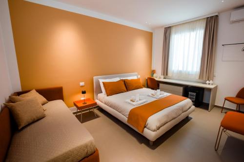 a hotel room with a bed and a desk at La Corte del Fante in Marsala