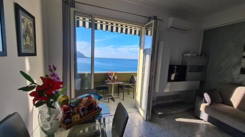 a living room with a glass table and a view of the ocean at CH Exclusive Apartments in Cefalù