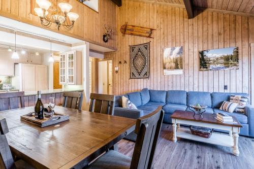 a living room with a blue couch and a table at Mountainback 80 in Mammoth Lakes