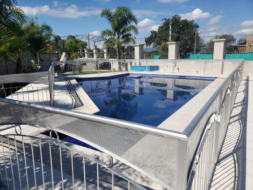 a swimming pool with a fence around it at Las Tres Marías in Salta