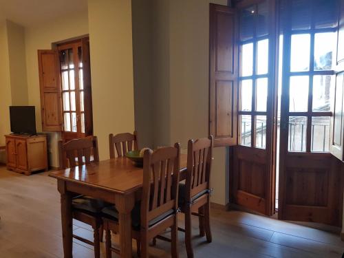a dining room with a wooden table and chairs at Cardona Fira in Cardona