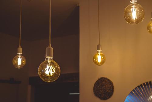 a group of lights hanging from a wall at apartamento Chilches playa in Chilches