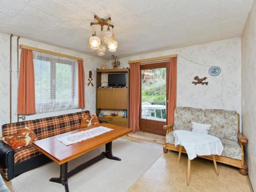 a living room with a couch and a table at Modern Chalet in Piller near Ski Area in Wenns