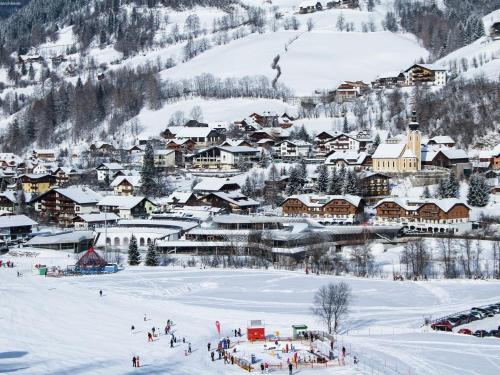 a group of people in the snow in a town at Apartment in Fresach near Ski Slopes in Fresach