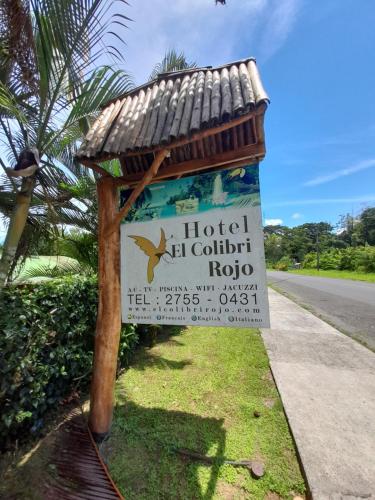 a sign on the side of a road at Hotel El Colibri Rojo - Cabinas - Le Colibri Rouge in Cahuita