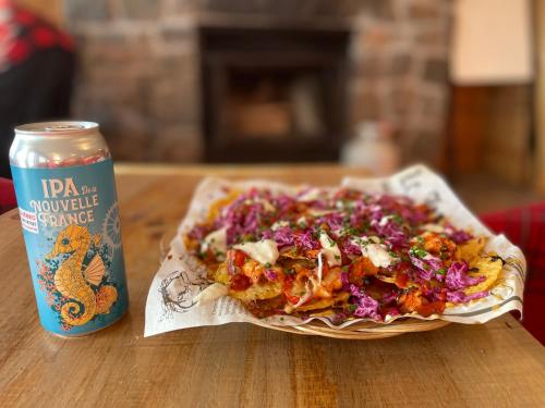 a plate of food on a table next to a can at Pourvoirie du Lac Blanc in Saint-Alexis-des-Monts