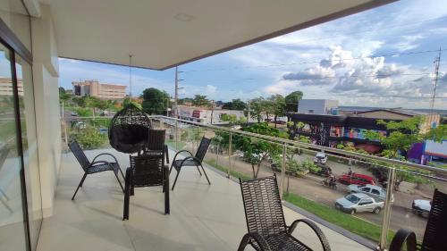 a balcony with chairs and a view of a city at Baruch Hotel in Araguaína