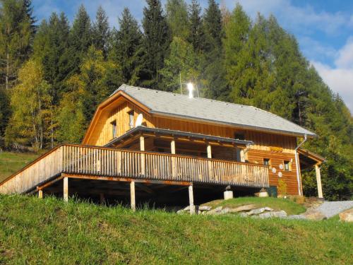 a large log cabin with a deck on a hill at Chalet in Styria near the ski area in Stadl an der Mur
