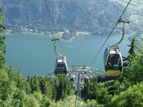 a group of gondolas on a ski lift over a lake at Apartment in Afritz near Ski Resorts in Afritz