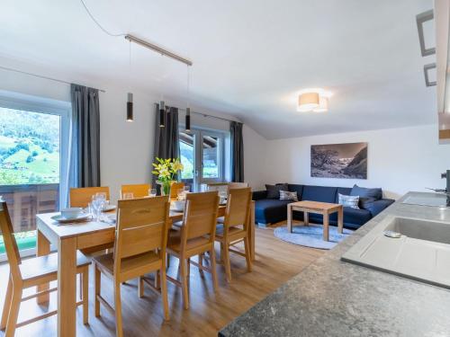 a kitchen and living room with a table and chairs at Beautiful Apartment in Salzburg with Balcony in Bramberg am Wildkogel