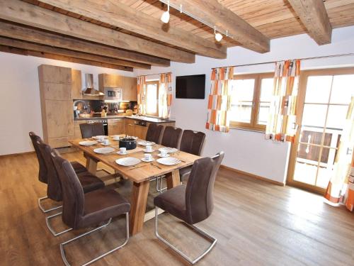 a dining room with a wooden table and chairs at Apartment in Kaprun near the ski area in Kaprun