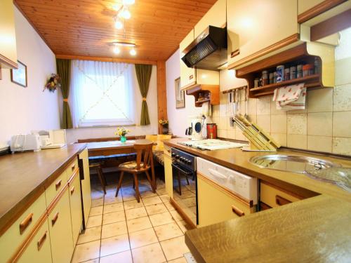 a kitchen with a sink and a table in it at Apartment in Feldkirchen near Ossiacher See in Feldkirchen in Kärnten