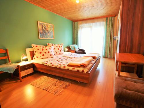 a bedroom with a bed with a green wall at Apartment in Feldkirchen near Ossiacher See in Feldkirchen in Kärnten