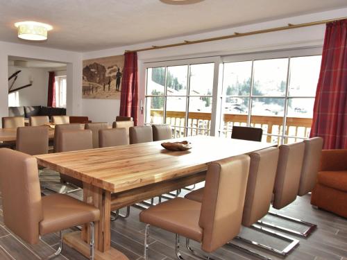 a dining room with a wooden table and chairs at Luxury Chalet in Saalbach Hinterglemm near Ski Area in Saalbach Hinterglemm