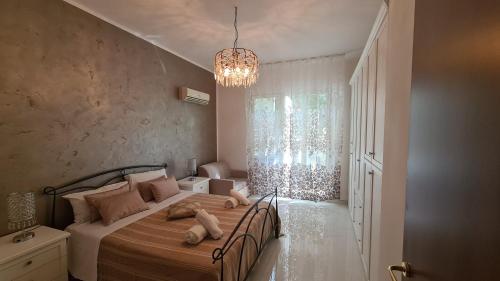um quarto com uma cama e um lustre em CH Exclusive Apartments em Cefalù