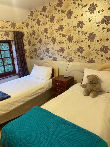 a bedroom with a bed and a window at The Laurels Bed and Breakfast in Cardiff