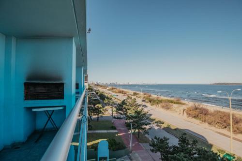 a view of the beach from the balcony of a building at Apart Hotel Punta Azul in Punta del Este