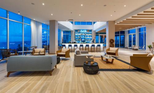 a lobby of a building with couches and chairs at Aquamare Hotel in San Andrés