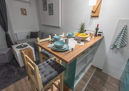 a kitchen with a table with bowls of fruit on it at Apartman Kesten - Апартман Кестен in Banja Koviljača