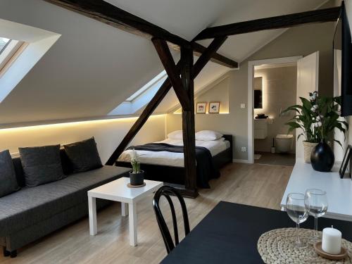 a living room with a bed and a couch at Apartamenty Delecta in Krakow