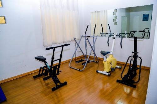 a room with exercise equipment on a wooden floor at VOA Hotel Rezende in Lambari