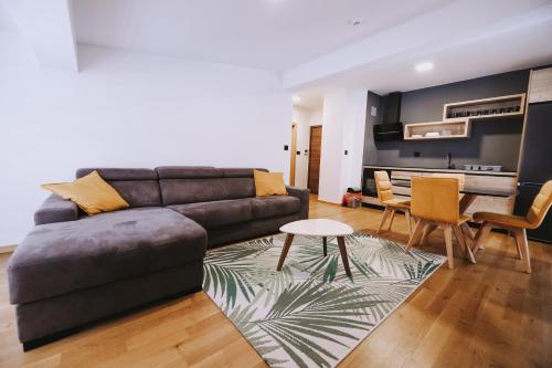 a living room with a couch and a table at Jahorinska Vila in Jahorina