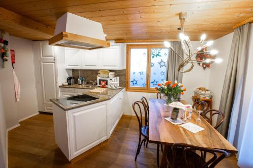 a kitchen with a table with chairs and a tableablish at Apartments Chalet Wirz Travel in Sarnen
