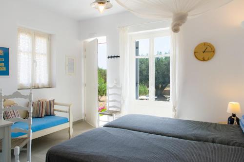 a bedroom with a bed and a clock on the wall at ROSE studio in Apollonia