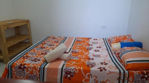 Ein Bett oder Betten in einem Zimmer der Unterkunft Hostal Casa Mathias
