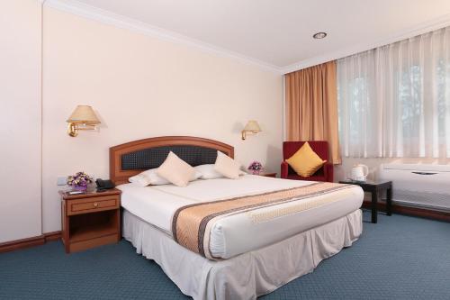 Giường trong phòng chung tại Hotel Sentosa