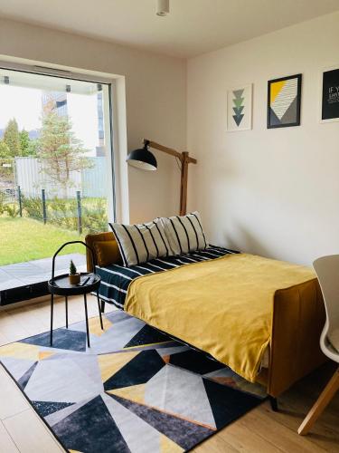 a bedroom with a bed and a couch and a window at Cubic Home in Rumia