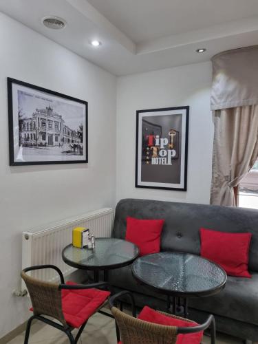 a living room with a couch and two tables at TipTop Hotel CITY CENTER in Chişinău