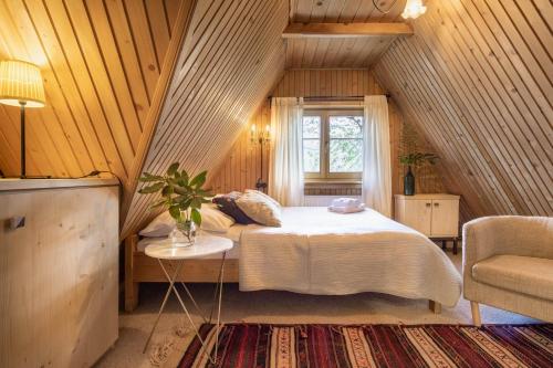 a bedroom with a bed and a window in a attic at Leśniczówka u Zięby in Witów