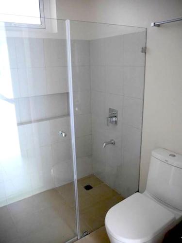 a bathroom with a glass shower with a toilet at Beach condos at Pico de Loro Cove - Wi-Fi & Netflix, 42-50''TVs with Cignal cable, Uratex beds & pillows, equipped kitchen, balcony, parking - guest registration fee is not included in Nasugbu