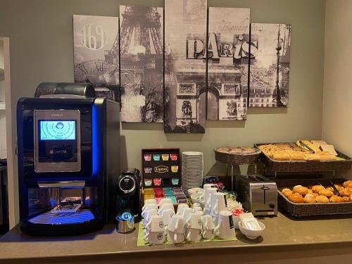 a counter with a cash register and some food at Holiday Inn Paris-Auteuil by IHG in Paris