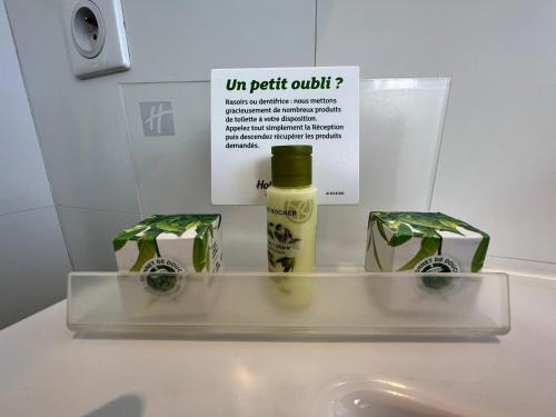 a bottle of oil sitting on top of a sink at Holiday Inn Paris-Auteuil by IHG in Paris