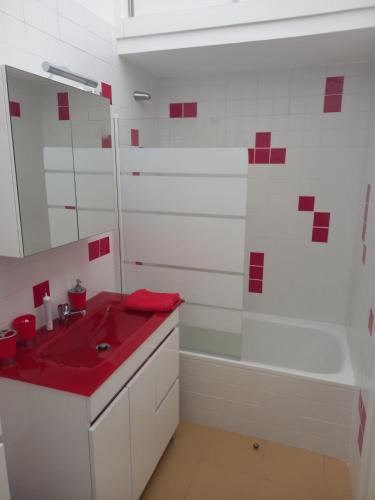 a bathroom with a red sink and a tub at Charming Beach Villa Porto Santo in Porto Santo