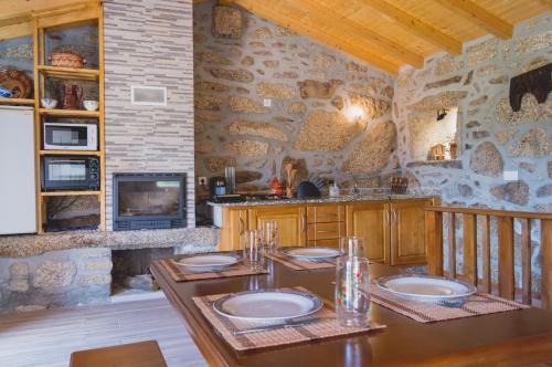 a kitchen with a table with plates on it at Casa do Penedo in Viana do Castelo