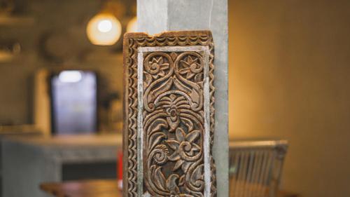 a wooden carving on the side of a wall at Adara Homestay in Banyuwangi