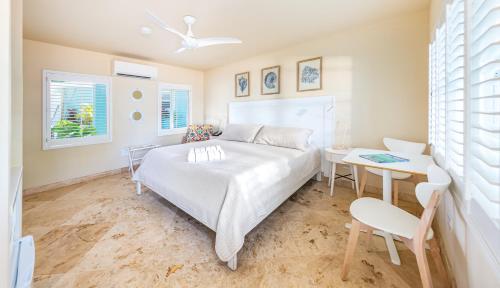 a bedroom with a bed and a table and a desk at Lime Tree Bay Resort in Islamorada