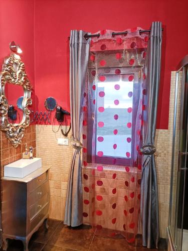 a bathroom with a shower with a sink and a mirror at Esencia Mudayyan in Coca de Alba