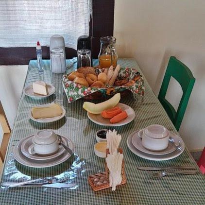 a table with a plate of food on it at Pousada do Abacateiro in Pirenópolis