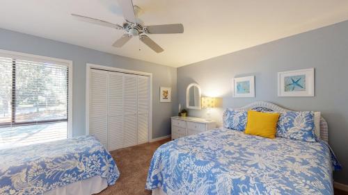a bedroom with a bed and a ceiling fan at 213 Turnberry Village in Hilton Head Island