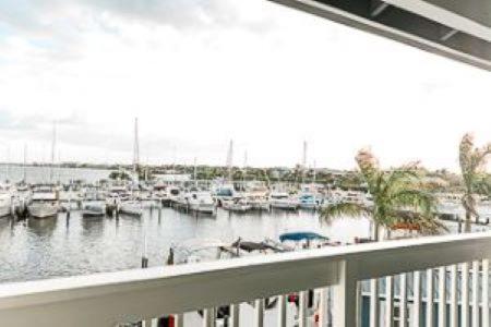 a balcony with a view of a marina with boats at The Suites at Fishermen's Village - 2 Bedroom Suites in Punta Gorda