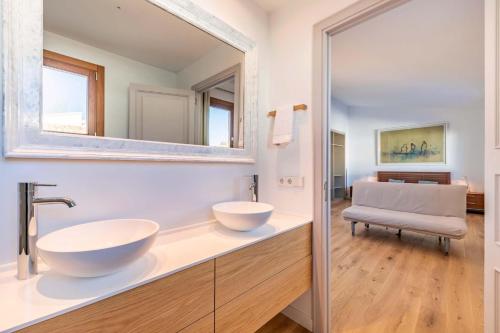 a bathroom with two sinks and a mirror at Seafront Villa Mar i Pins by Sealand Villas in Port de Pollensa
