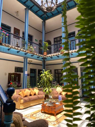 a living room with couches and a table in a building at Hotel Montecarlo in Riobamba